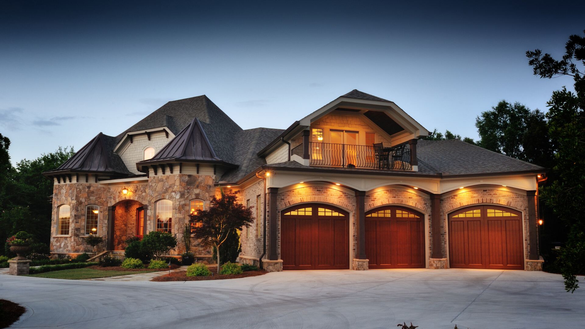luxury-villa-exterior-with-stone-facade-and-garage-at-dusk